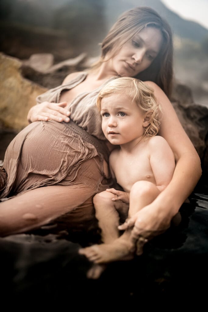 Maternity Photographer, an expectant mother has her arm around her other toddler child